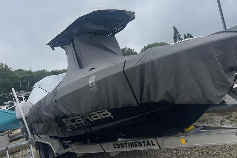 Slide: The Image of 2022 Wellcraft 222 Fisherman boat covered on trailer, ready for transport. - 2