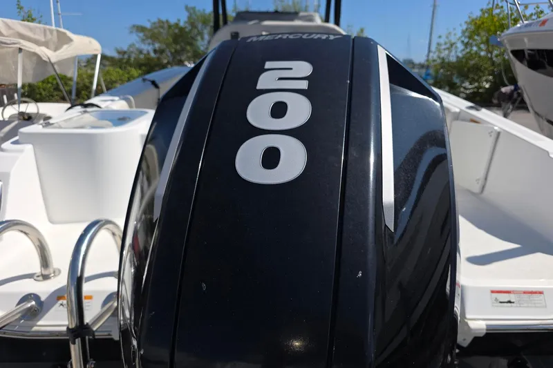 Slide: The Image of 2022 Wellcraft 222 Fisherman boat with Mercury 200 engine, docked outdoors. - 6