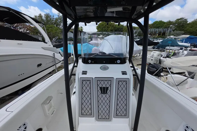 Slide: The Image of 2022 Wellcraft 222 Fisherman boat interior with console and surrounding boats. - 9