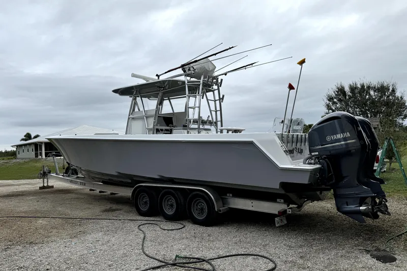 Slide: The Image of 2014 Contender 39 ST boat on trailer with Yamaha outboard engines. - 13