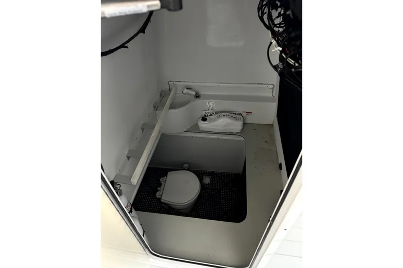 Slide: The Image of 2014 Contender 39 ST boat interior with compact marine toilet and sink. - 18