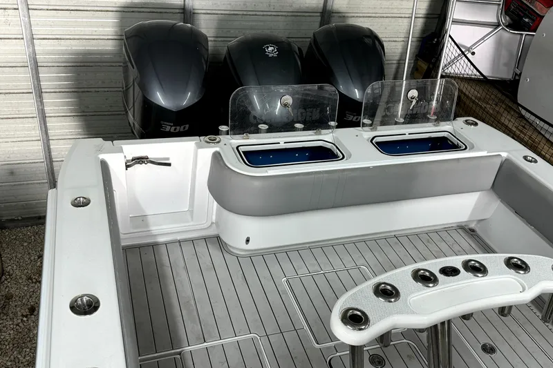 Slide: The Image of 2014 Contender 39 ST boat with triple Yamaha 300 engines and fishing rod holders. - 20