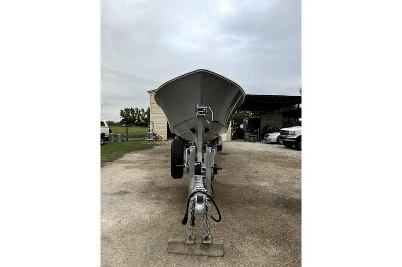 Slide: The Image of 2014 Contender 39 ST boat on trailer, parked outdoors on a cloudy day. - 4