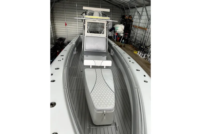 Slide: The Image of 2014 Contender 39 ST boat in storage, featuring sleek design and spacious deck. - 6