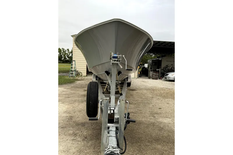 Slide: The Image of 2014 Contender 39 ST boat on trailer, parked outdoors near a building. - 7