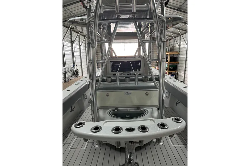 Slide: The Image of 2014 Contender 39 ST boat interior with fishing rod holders and control panel. - 8