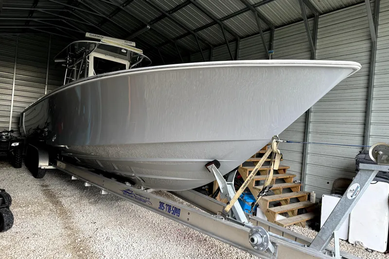 Slide: The Image of 2014 Contender 39 ST boat on trailer in a metal storage shed. - 9