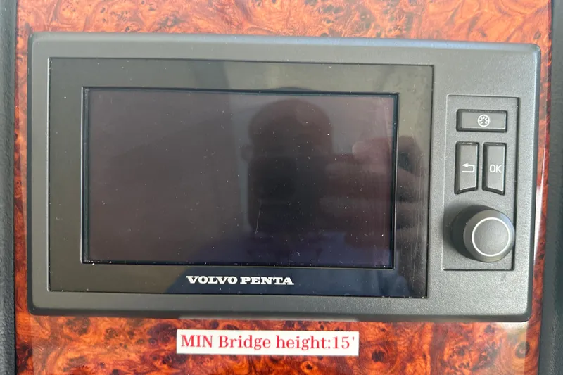 Slide: The Image of Volvo Penta control panel on 2011 Cruisers Yachts 540 Sports Coupe, wood finish background. - 10