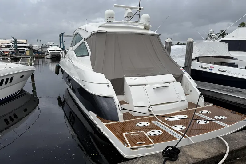 Slide: The Image of 2011 Cruisers Yachts 540 Sports Coupe docked at marina, rear view. - 2
