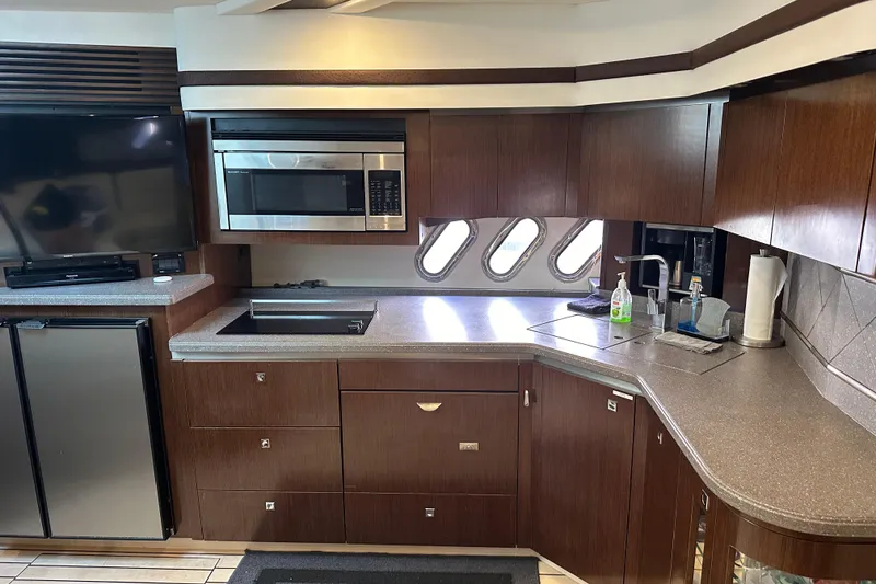 Slide: The Image of Luxurious 2011 Cruisers Yachts 540 Sports Coupe kitchen with modern appliances and sleek design. - 27