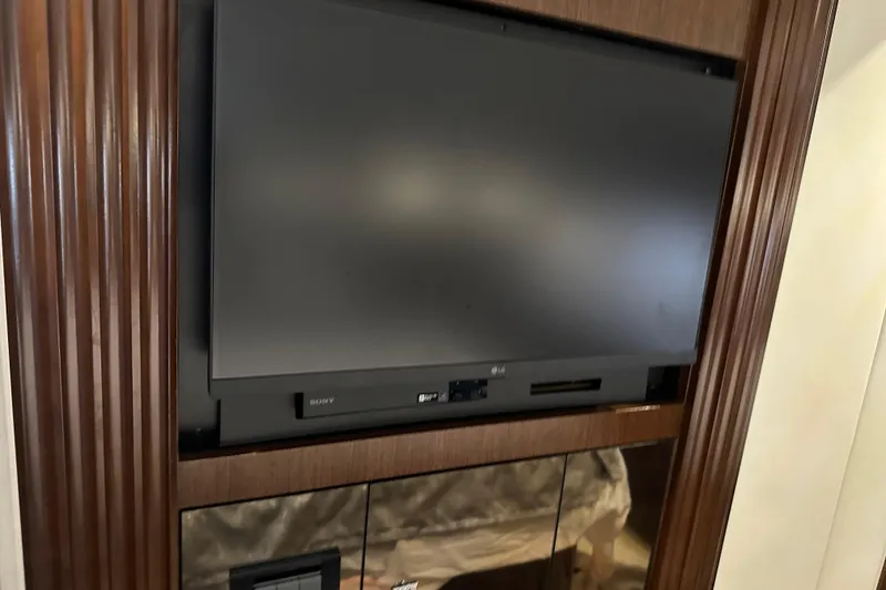 Slide: The Image of Flat-screen TV in 2011 Cruisers Yachts 540 Sports Coupe interior, wooden paneling. - 33