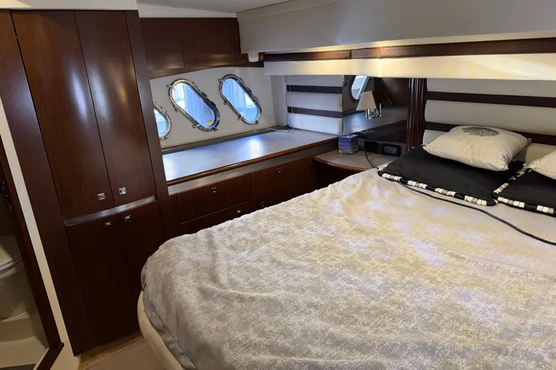 Slide: The Image of Luxurious cabin interior of 2011 Cruisers Yachts 540 Sports Coupe with elegant wood finish. - 51