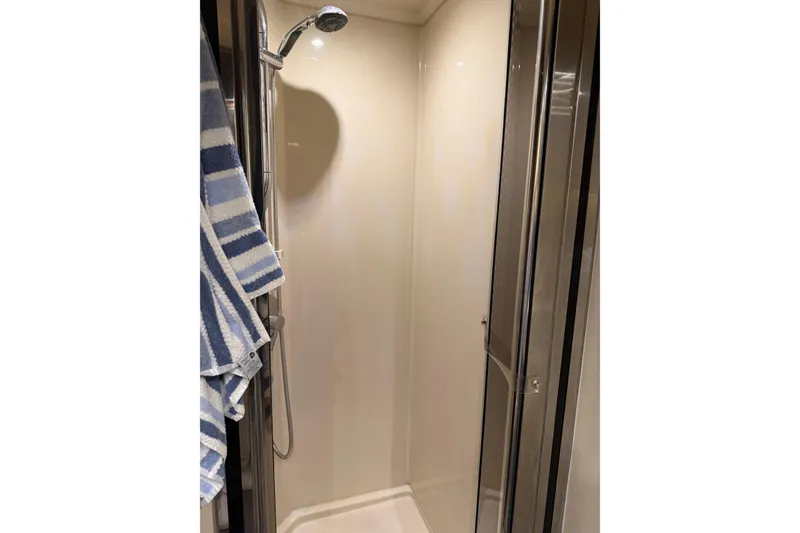 Slide: The Image of Shower area in 2011 Cruisers Yachts 540 Sports Coupe with striped towel. - 54