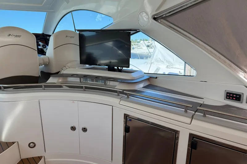 Slide: The Image of 2011 Cruisers Yachts 540 Sports Coupe interior with helm, seating, and entertainment system. - 58