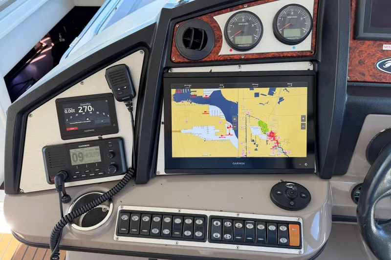 Slide: The Image of 2011 Cruisers Yachts 540 Sports Coupe dashboard with Garmin navigation and control panel. - 62
