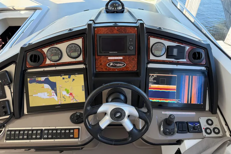 Slide: The Image of 2011 Cruisers Yachts 540 Sports Coupe helm with navigation screens and controls. - 63