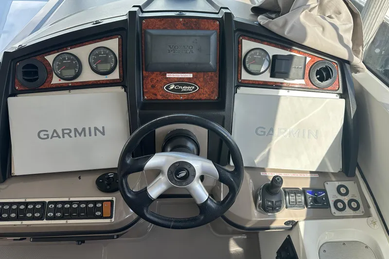 Slide: The Image of 2011 Cruisers Yachts 540 Sports Coupe dashboard with Garmin navigation and Volvo Penta controls. - 7