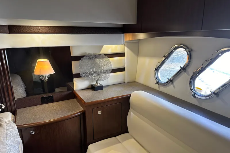 Slide: The Image of Luxurious interior of 2011 Cruisers Yachts 540 Sports Coupe with elegant decor and porthole windows. - 23