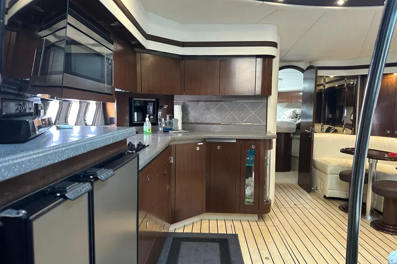 Slide: The Image of Luxurious interior of 2011 Cruisers Yachts 540 Sports Coupe with modern kitchen and seating area. - 24