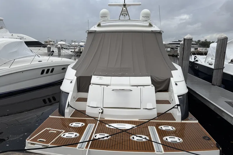 Slide: The Image of 2011 Cruisers Yachts 540 Sports Coupe docked at marina, rear view. - 3