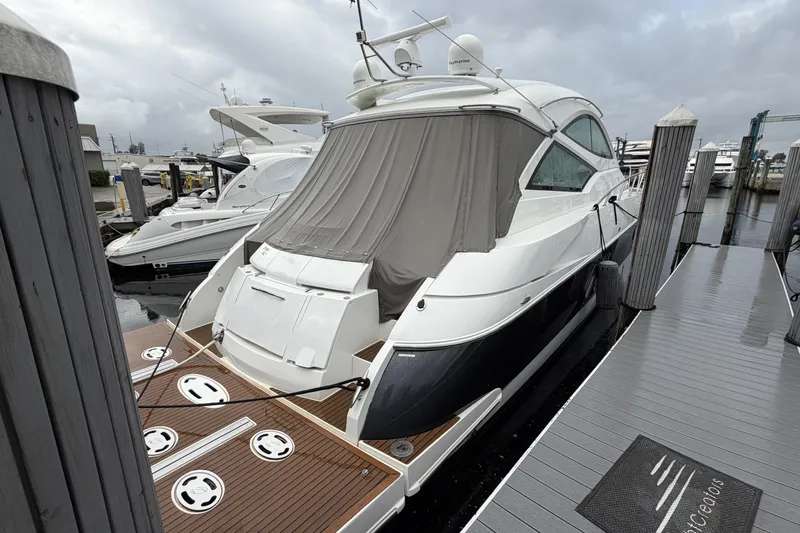 Slide: The Image of 2011 Cruisers Yachts 540 Sports Coupe docked at marina, rear view. - 4