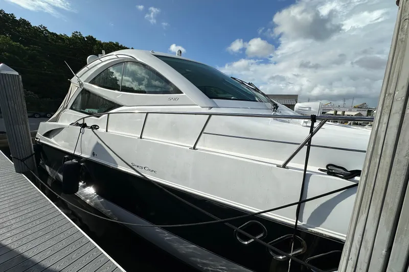 Slide: The Image of 2011 Cruisers Yachts 540 Sports Coupe docked under a cloudy sky. - 42