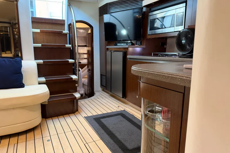 Slide: The Image of Interior of 2011 Cruisers Yachts 540 Sports Coupe with modern kitchen and wooden stairs. - 46