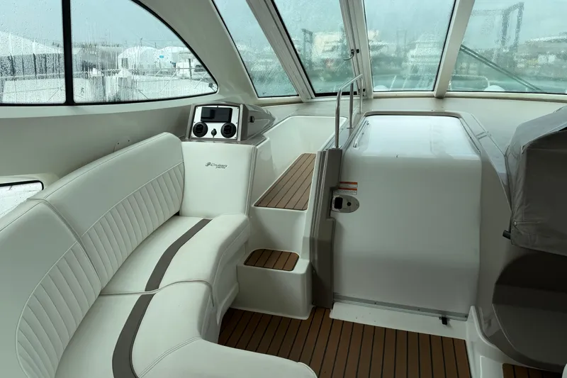 Slide: The Image of Interior of 2011 Cruisers Yachts 540 Sports Coupe with white seating and wood accents. - 5