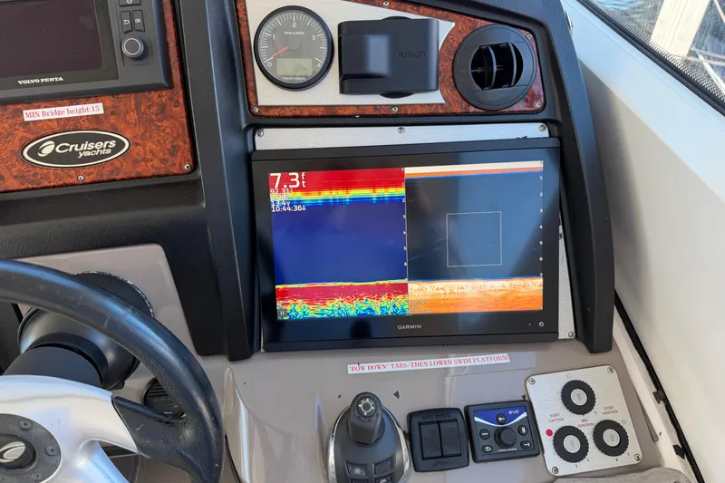 Slide: The Image of 2011 Cruisers Yachts 540 Sports Coupe dashboard with Garmin display and controls. - 65