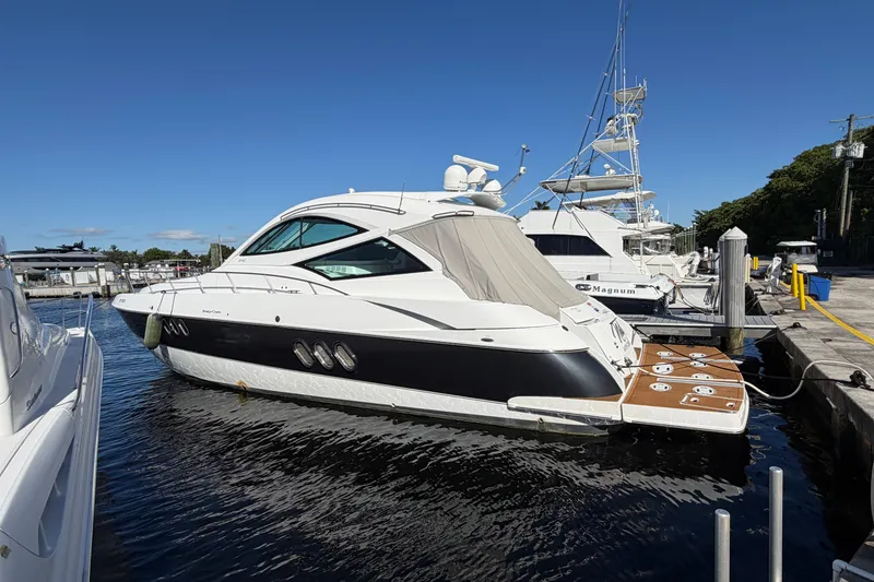 Slide: The Image of 2011 Cruisers Yachts 540 Sports Coupe docked at marina under clear blue sky. - 68