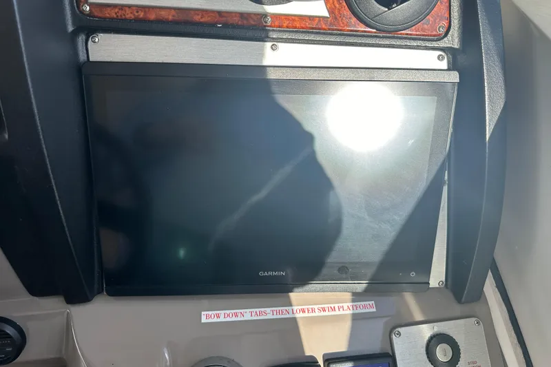 Slide: The Image of 2011 Cruisers Yachts 540 Sports Coupe dashboard with Garmin display and control panel. - 9