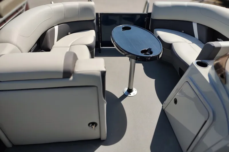 Slide: The Image of Luxurious seating area on 2026 Sylvan MIRAGE X1 CLZ DH pontoon boat with central table. - 10