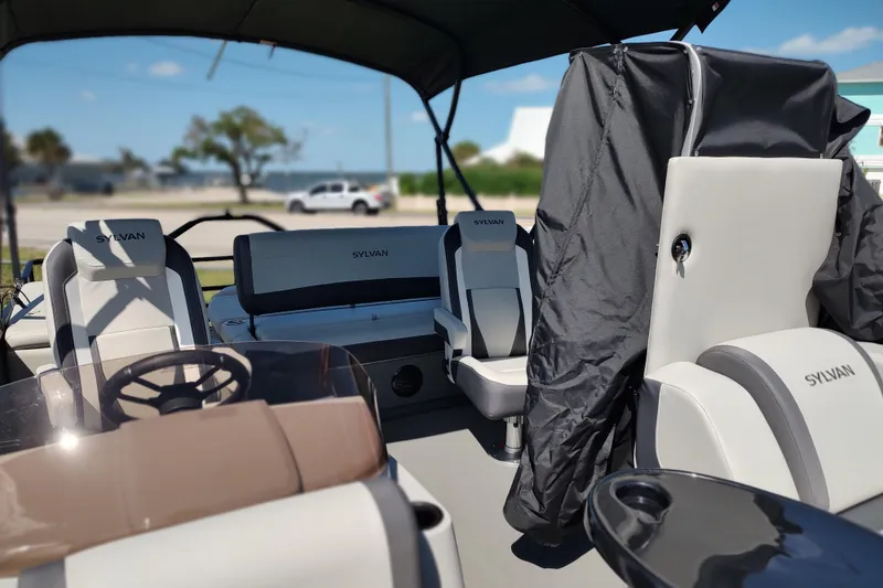 Slide: The Image of Interior of 2026 Sylvan MIRAGE X1 CLZ DH pontoon boat with stylish seating and steering wheel. - 11
