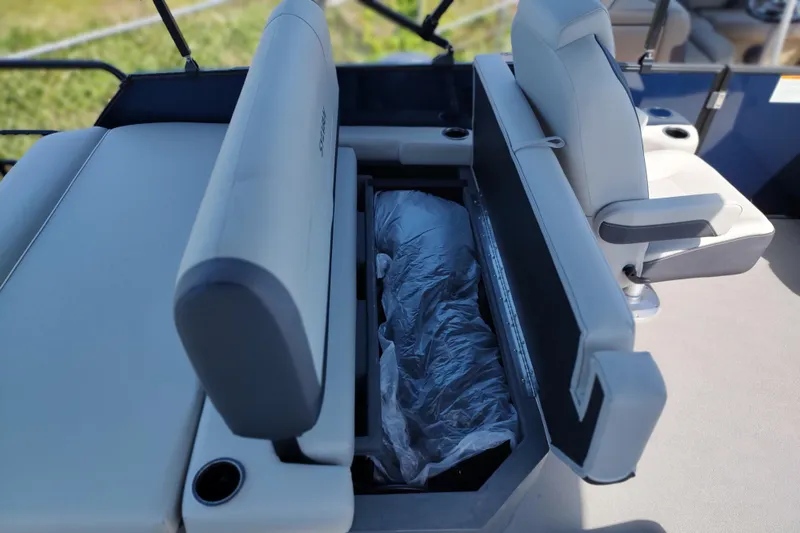 Slide: The Image of 2026 Sylvan MIRAGE X1 CLZ DH boat interior with open storage compartment and seating. - 16