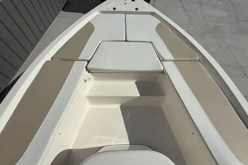 Slide: The Image of 2026 Bulls Bay 230 Center Console boat interior with cushioned seating. - 12