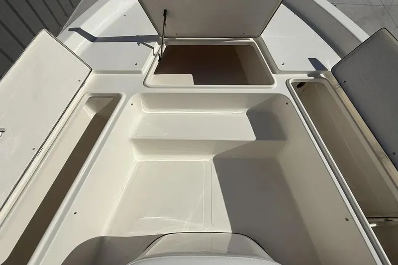 Slide: The Image of 2026 Bulls Bay 230 Center Console boat storage compartments open, showcasing spacious design. - 14