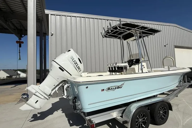Slide: The Image of 2026 Bulls Bay 230 Center Console boat with Suzuki outboard motor on trailer. - 3