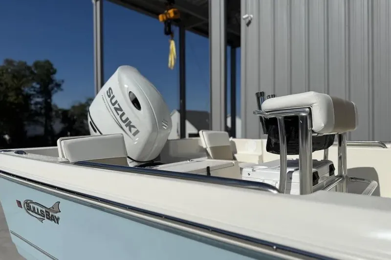 Slide: The Image of 2026 Bulls Bay 230 Center Console boat with Suzuki engine, docked in sunlight. - 4