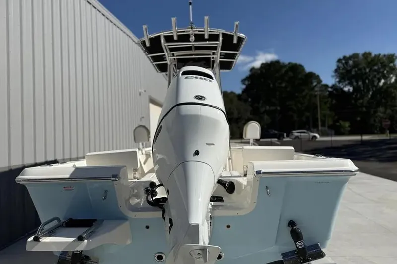 Slide: The Image of 2026 Bulls Bay 230 Center Console boat with powerful outboard motor, docked outdoors. - 5