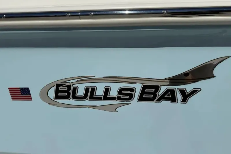 Slide: The Image of Bulls Bay 230 Center Console 2026 logo with American flag on boat exterior. - 7