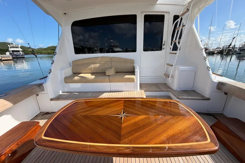 Slide: The Image of Luxurious 2004 Viking 56 Convertible yacht interior with elegant wood table and comfortable seating. - 15