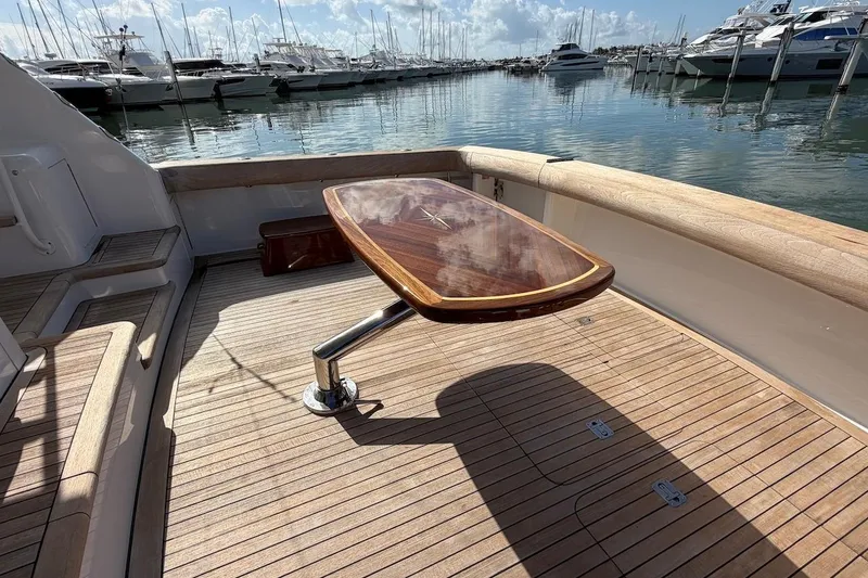 Slide: The Image of Teak deck and table on 2004 Viking 56 Convertible yacht at marina. - 16