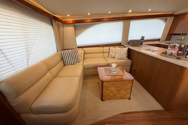 Slide: The Image of Luxurious interior of 2004 Viking 56 Convertible yacht with beige seating and elegant decor. - 18