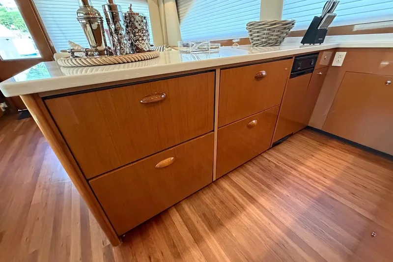 Slide: The Image of 2004 Viking 56 Convertible yacht interior with wooden cabinetry and modern decor. - 22