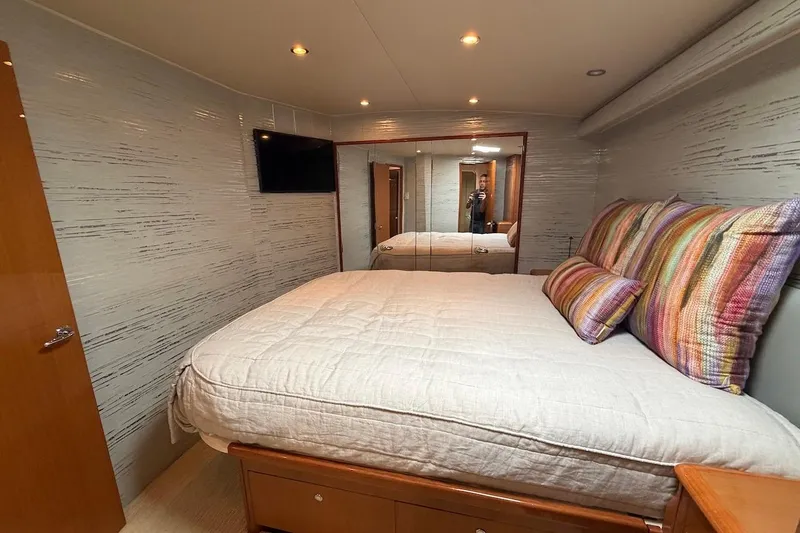 Slide: The Image of Luxurious bedroom interior of 2004 Viking 56 Convertible yacht with cozy bedding and modern decor. - 26