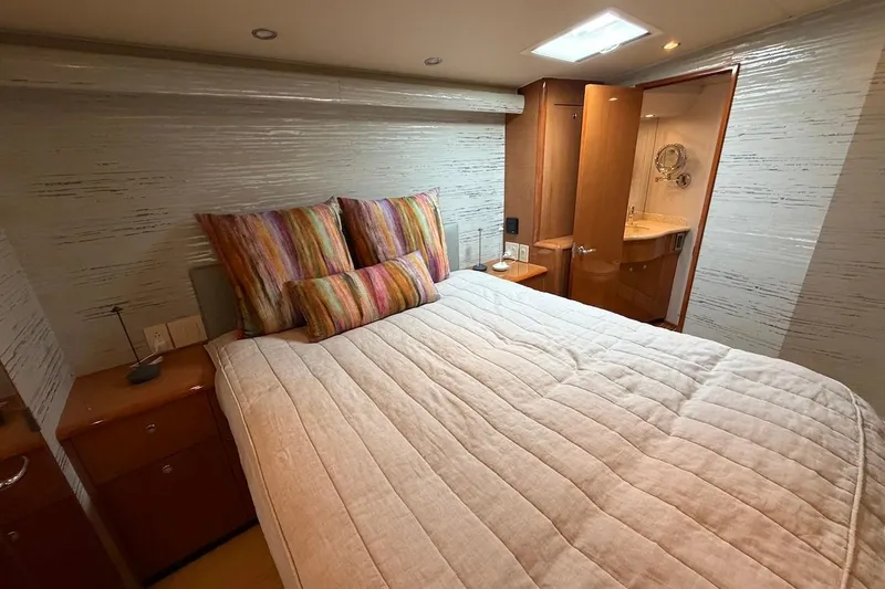 Slide: The Image of Luxurious bedroom interior of 2004 Viking 56 Convertible yacht with ensuite bathroom. - 27