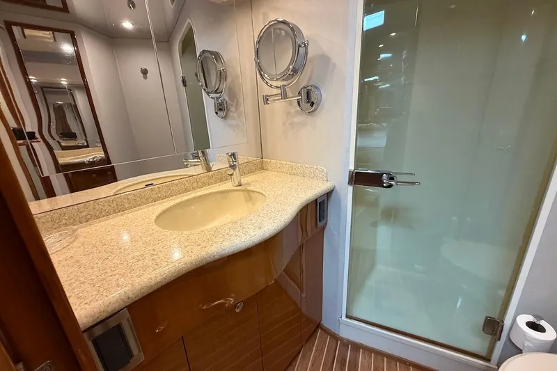 Slide: The Image of Luxurious bathroom in 2004 Viking 56 Convertible yacht with glass shower and elegant vanity. - 28