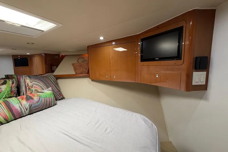 Slide: The Image of Luxurious cabin interior of 2004 Viking 56 Convertible yacht with TV and colorful bedding. - 30