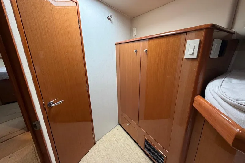 Slide: The Image of Interior of 2004 Viking 56 Convertible yacht with wooden cabinetry and door. - 34