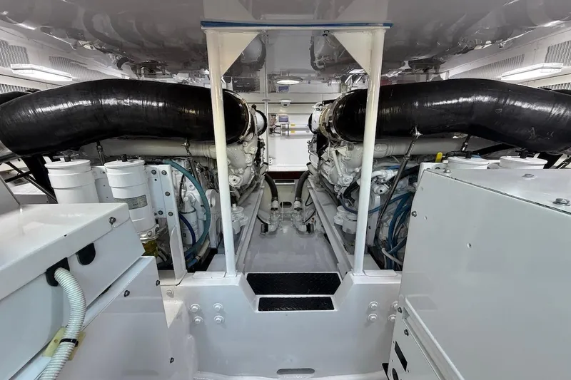 Slide: The Image of Engine room of a 2004 Viking 56 Convertible yacht, showcasing dual engines and mechanical components. - 35